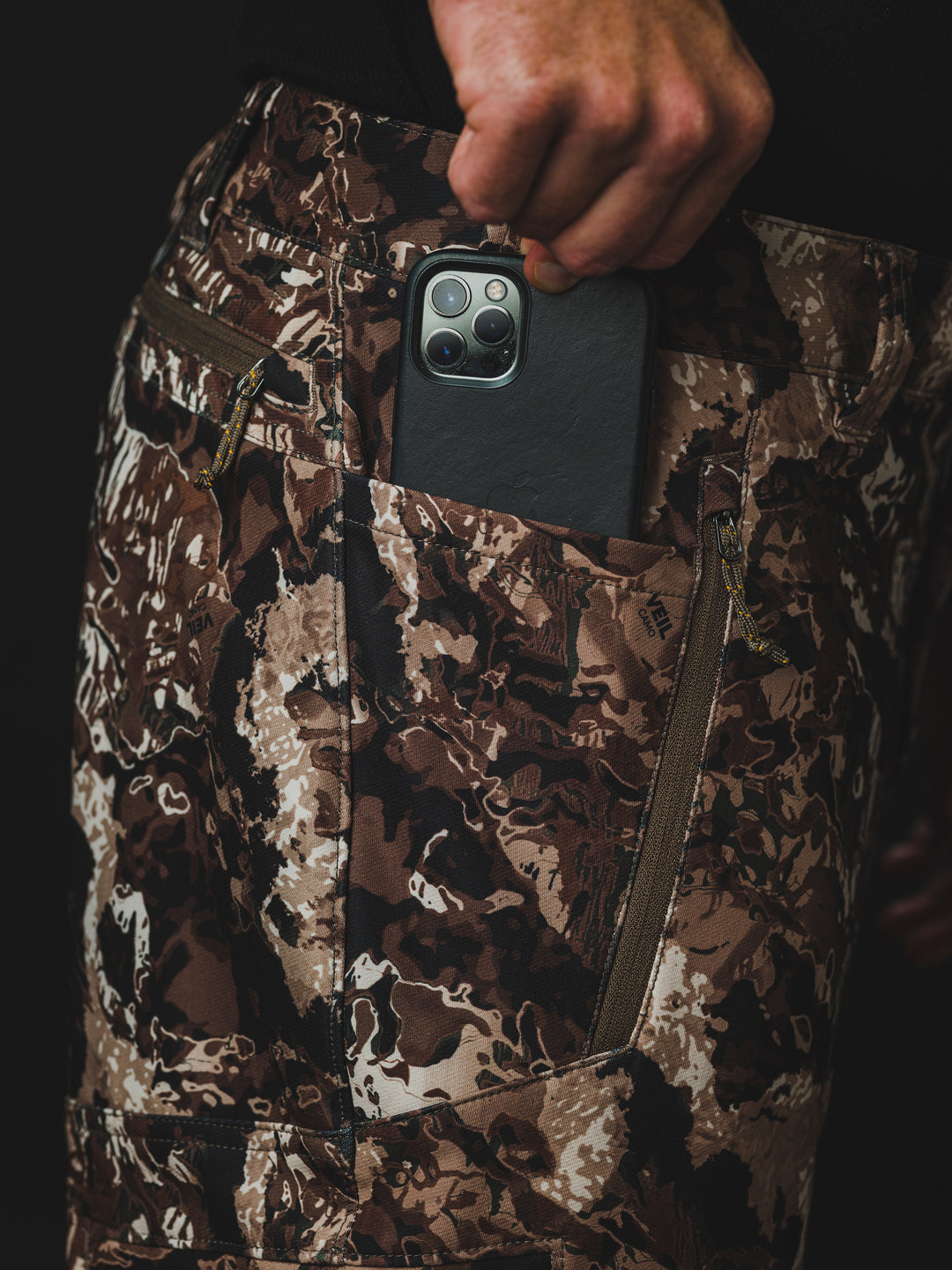 The Veil® Camo Field Pant is the most talked-about pant coming out for your next hunt. This multi-season, multi-purpose pant is comfortable and offers an athletic fit. With double weave 4-way stretch you can't go wrong with this pant!  PROTECTION Quick-drying, Windproof, Water Resistant. MATERIAL Exterior: 92% Polyester 8% Synthetic Fiber. FIT: Midweight and Multi-Season. CONDITIONS Mild, Dry, Cold, Wet, Wind. PATTERN Veil® Camo in Grind.Multi-Season Gear & Pursuits