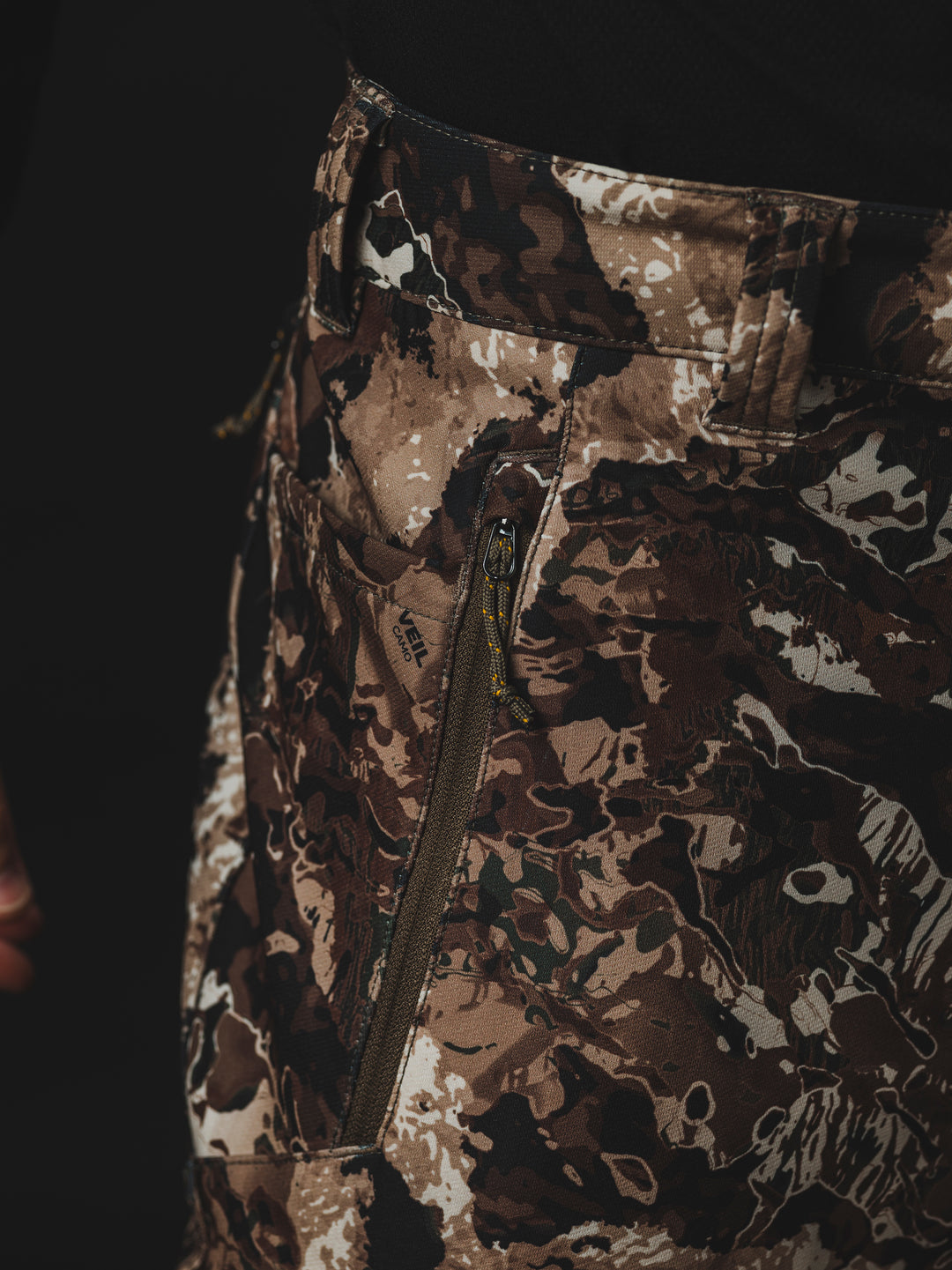 The Veil® Camo Field Pant is the most talked-about pant coming out for your next hunt. This multi-season, multi-purpose pant is comfortable and offers an athletic fit. With double weave 4-way stretch you can't go wrong with this pant!  PROTECTION Quick-drying, Windproof, Water Resistant. MATERIAL Exterior: 92% Polyester 8% Synthetic Fiber. FIT: Midweight and Multi-Season. CONDITIONS Mild, Dry, Cold, Wet, Wind. PATTERN Veil® Camo in Grind.Multi-Season Gear & Pursuits