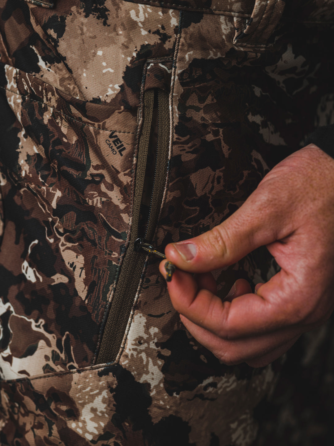The Veil® Camo Field Pant is the most talked-about pant coming out for your next hunt. This multi-season, multi-purpose pant is comfortable and offers an athletic fit. With double weave 4-way stretch you can't go wrong with this pant!  PROTECTION Quick-drying, Windproof, Water Resistant. MATERIAL Exterior: 92% Polyester 8% Synthetic Fiber. FIT: Midweight and Multi-Season. CONDITIONS Mild, Dry, Cold, Wet, Wind. PATTERN Veil® Camo in Grind.Multi-Season Gear & Pursuits